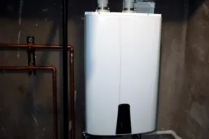 Tankless water heater installed in a basement utility room, showcasing energy-efficient design and space-saving features, relevant to benefits discussed for Tracy, CA homeowners.