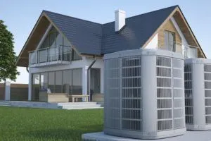 Modern house with heat pump units outside, emphasizing energy-efficient heating solutions for winter comfort.