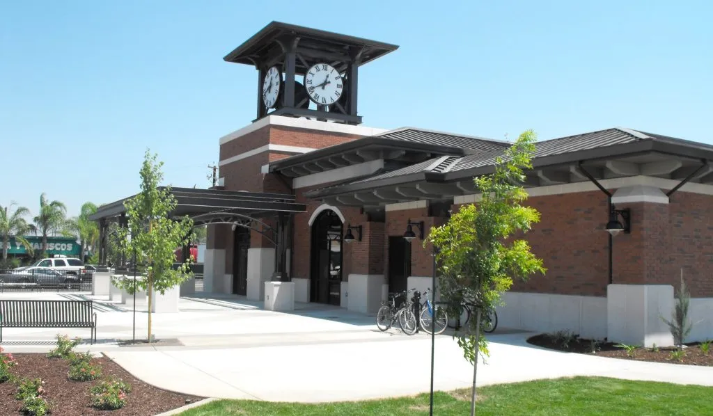 Manteca Transit Center building with clock tower, landscaped area, and bike racks, serving as a local landmark for Dycus Heating and Air Conditioning's AC repair services.