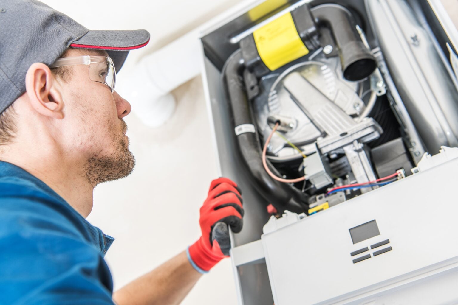 Technician servicing a gas furnace, furnace repair and replacement in Hughson, CA