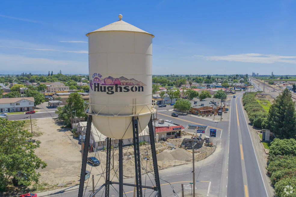 The Hughson water tower, painted with the city name, above downtown Hughson and the neighborhoods Dycus Heating and Air Conditioning serves in Hughson, CA
